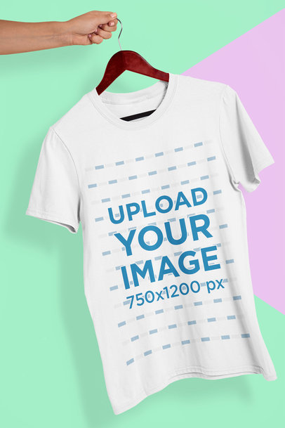 Mockup of a Hand Holding a T-Shirt in a Colorful Background