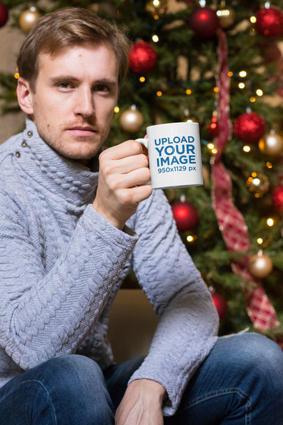 11 oz Mug Mockup of a Man Having a Coffee by a Christmas Tree 