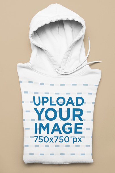 Mockup of a Folded Pullover Hoodie Against a Solid Surface