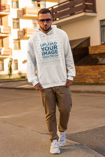 Hoodie Mockup of a Serious Man with Sunglasses Walking on the Street