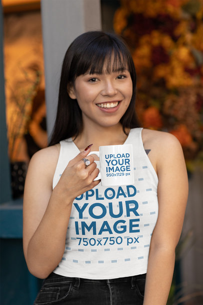 Tank Top Mockup of a Woman Holding a Coffee Mug and Smiling at the Camera