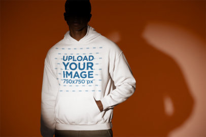Gildan Pullover Hoodie Mockup Featuring a Serious Man Under a Spotlight