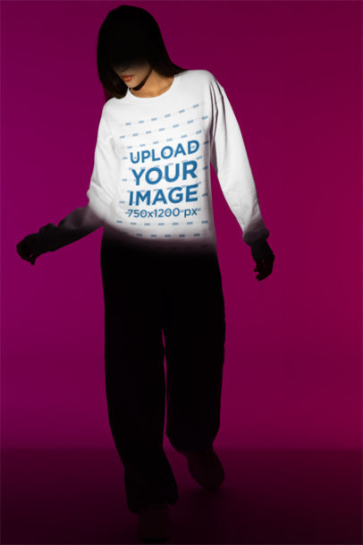 Sweatshirt Mockup Featuring a Woman Standing on the Spotlight of an Indoor Studio m50009